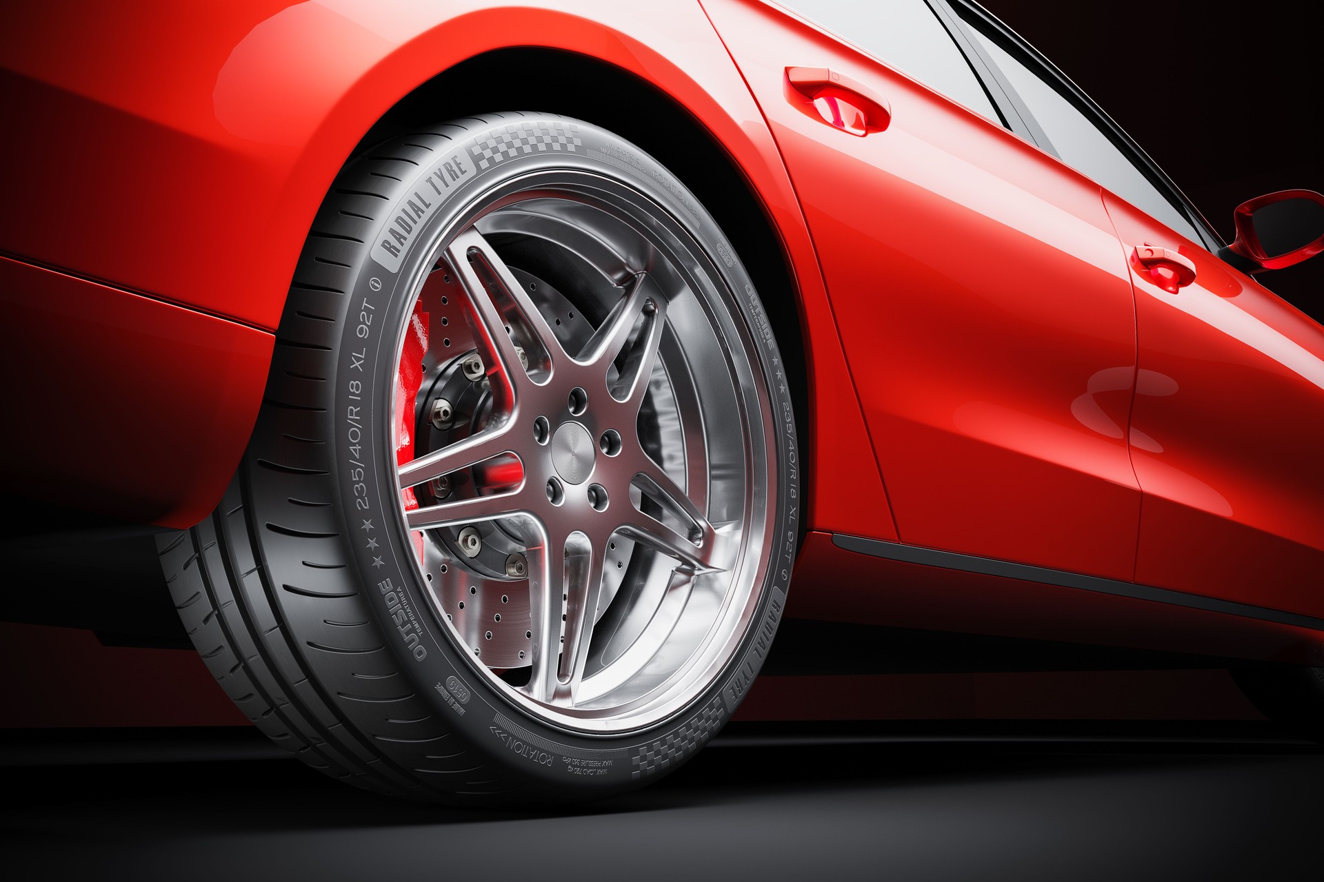 Wheel of red sports car closeup in studio lighting